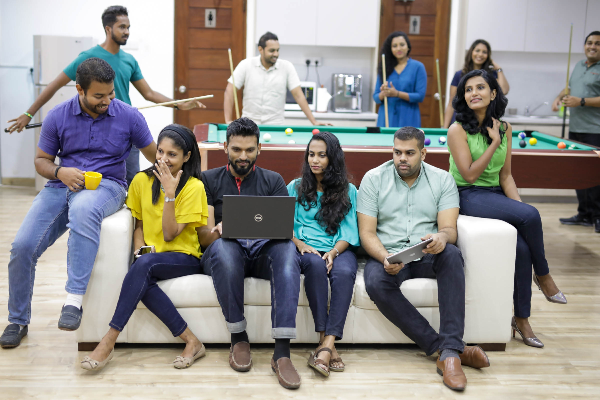 Cambio staff sitting on sofa, enjoying themselves.