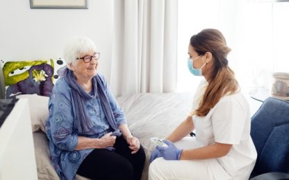 Nurse with elderly woman at home