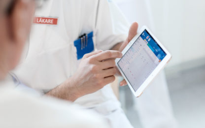 Medical staff pointing at a tablet